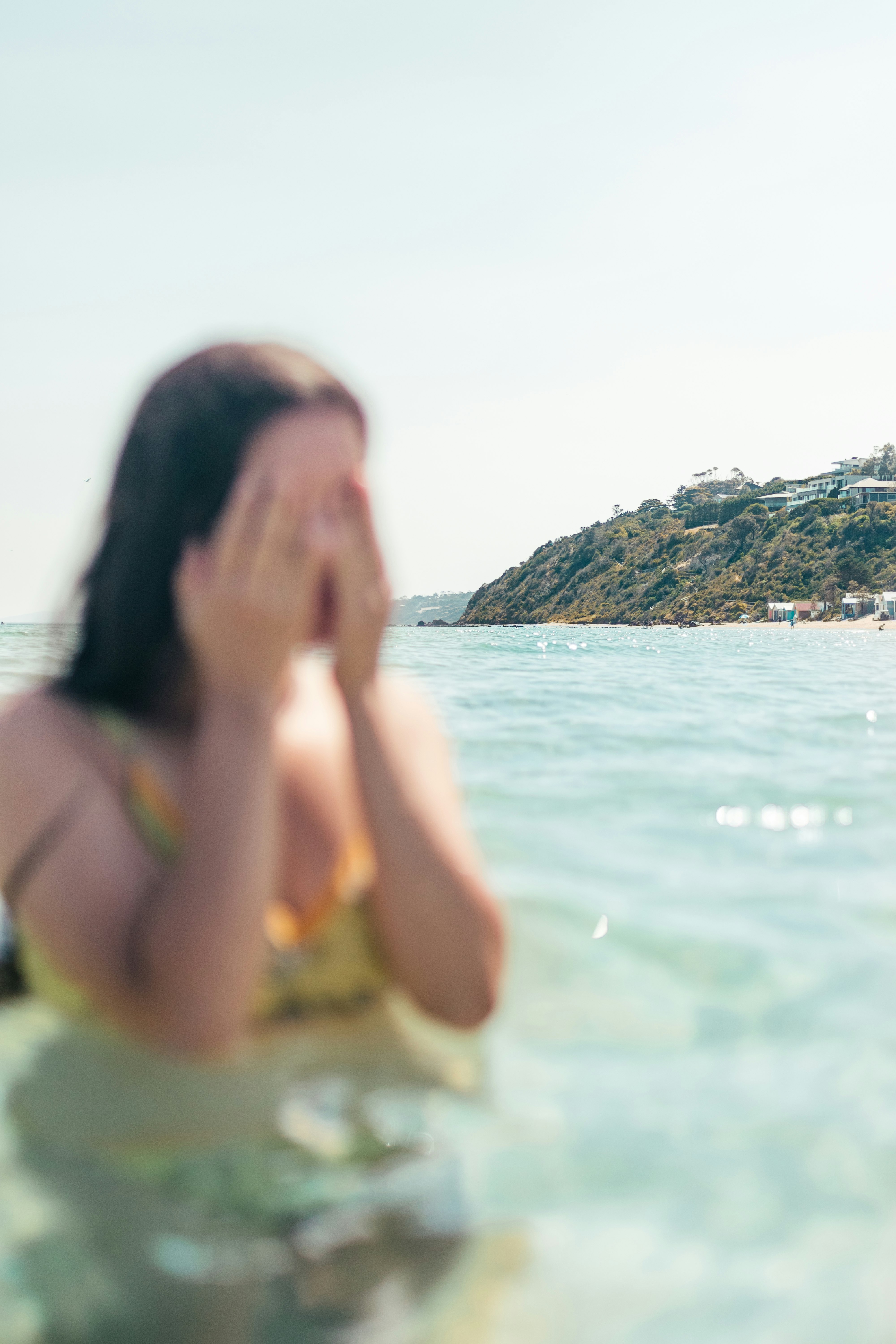 woman in pink tank top on water during daytime